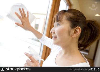 Japanese woman wiping window