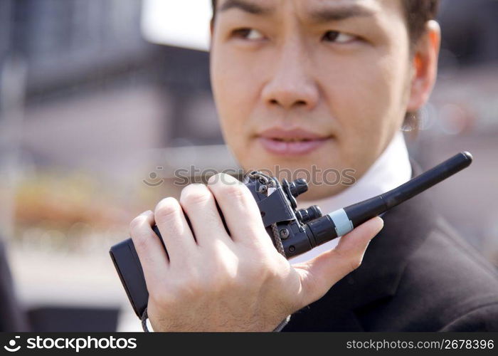 Japanese worker communicating by transceiver