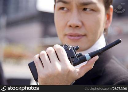 Japanese worker communicating by transceiver