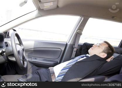 Japanese worker napping in a car
