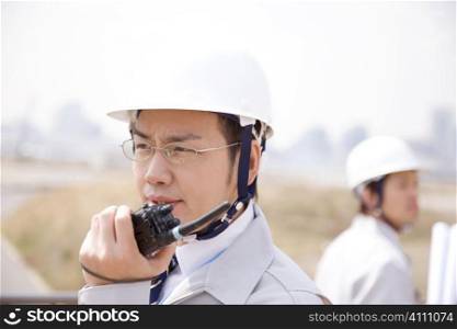 Japanese worker talking with a transceiver