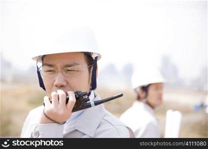Japanese worker talking with a transceiver