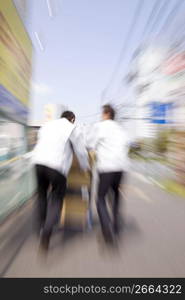 Japanese workers carrying corrugated cardboards