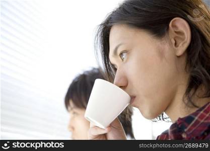 Japanese young man drinking coffee