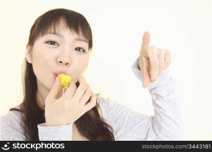 Japanese young woman blowing a whistle