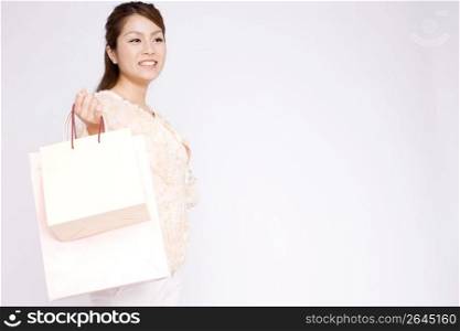 Japanese young woman carrying paper bags