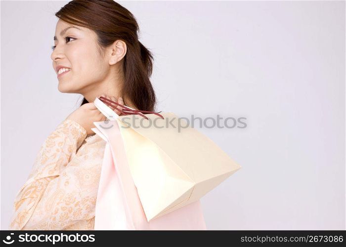 Japanese young woman carrying paper bags