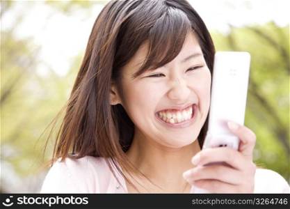 Japanese young woman checking a cellphone