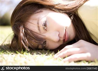 Japanese young woman napping on the ground