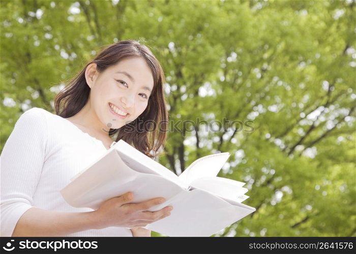 Japanese young woman reading a book