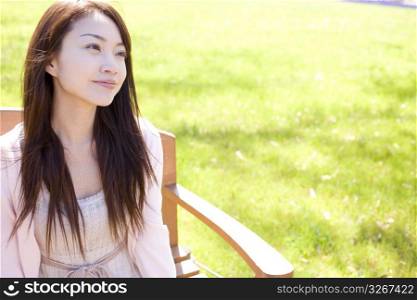 Japanese young woman sitting on the bench