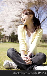 Japanese young woman sitting on the ground