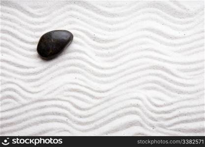 Japanese zen rock garden with white raked sand