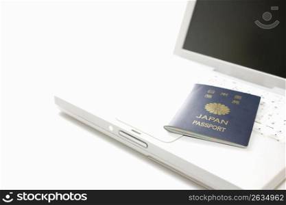 japanesse passport laying on a laptop keyboard