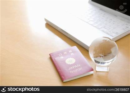 Japanesse passport next to a laptop