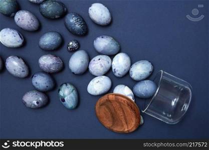 jar and painted blue eggs on a blue background, flat lay. jar and eggs