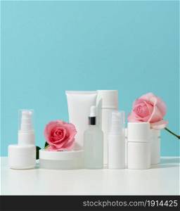 jar, bottle and empty white plastic tubes for cosmetics on a white table. Packaging for cream, gel, serum, advertising and product promotion, mock up