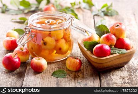 jar of apple jam with fresh fruits on wooden table