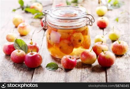 jar of apple jam with fresh fruits on wooden table