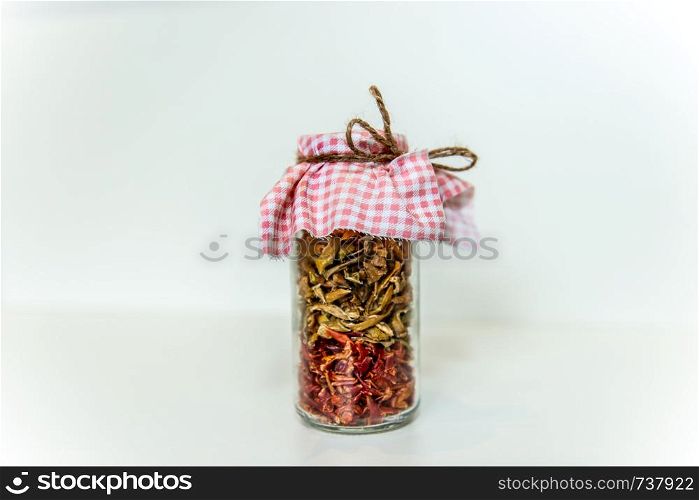 jar of dried spices. Red and green peppers in a glass jar. Grandma's blanks. Homemade sun dried red and green peppers in a glass jar