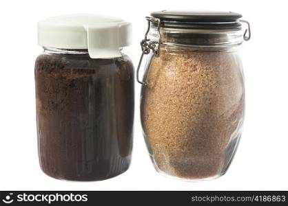 jar of ground coffee and sugar cane on white background