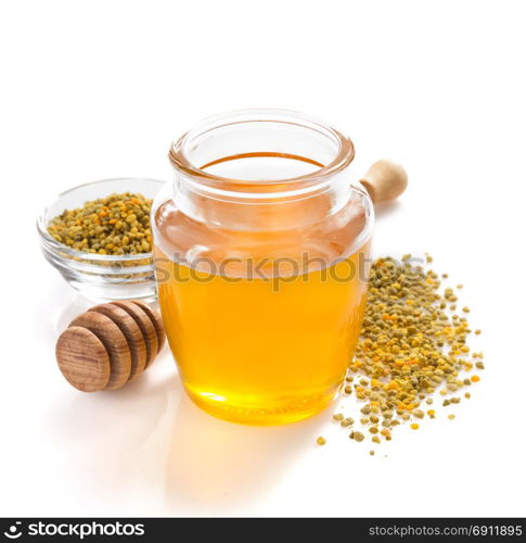 jar of honey and bee pollen isolated on white background