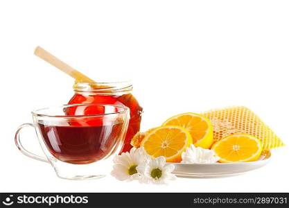 Jar of honey and tea cup isolated over white