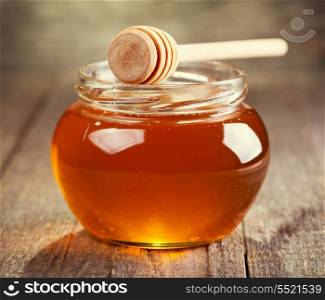jar of honey on wooden table