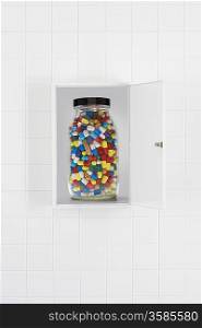 Jar of pills in bathroom cabinet