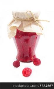 Jar of raspberry jam and fresh fruits