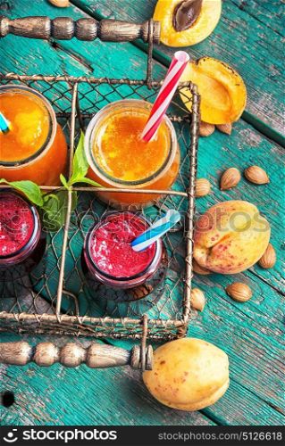 jar with apricot smoothies. smoothies with ripe apricot and currant berries