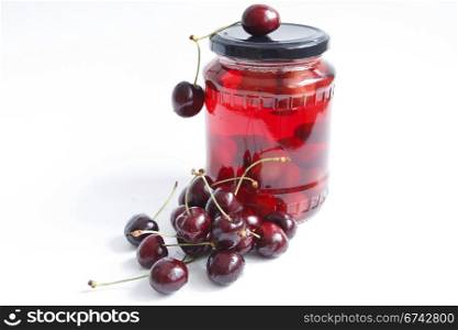 jar with red cherry against the white background