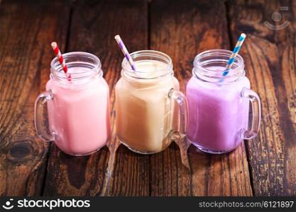 jars of fruit smoothie with striped straws