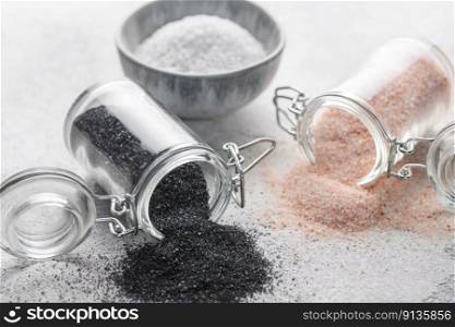 Jars of Hawaiian black  lava sea salt and himalayan pink salt.  Healthy food concept. Speciality salt.