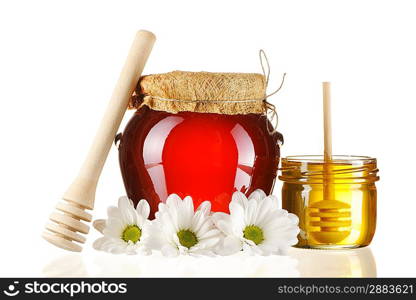 Jars of honey and dipper isolated over white