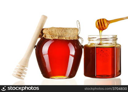 Jars of honey and dipper isolated over white