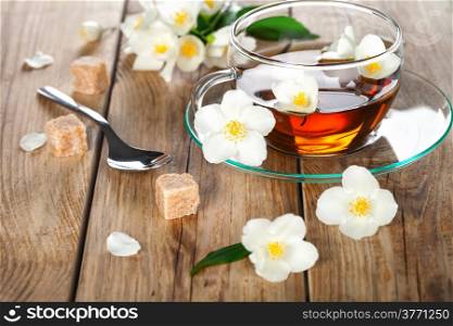 Jasmine tea with jasmine herb flower on wooden table background