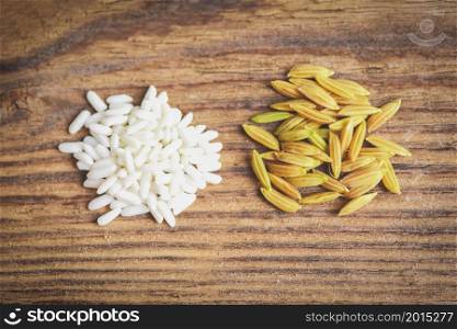 Jasmine white rice and yellow paddy rice in wooden harvested rip rice, harvest rice and food grains cooking concept