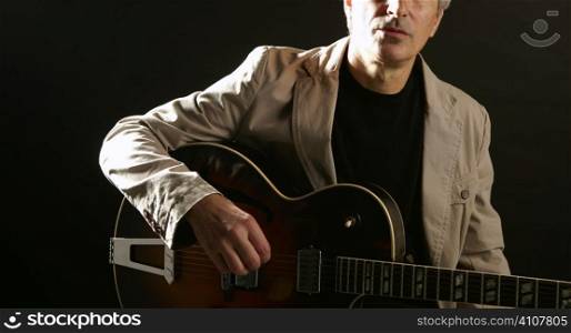 Jazz guitar player playing classic instrument