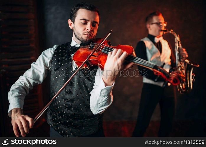 Jazz man and violinst, classical musical duet. Sax and fiddle music players