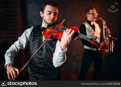 Jazz man and violinst, classical musical duet. Sax and fiddle music players