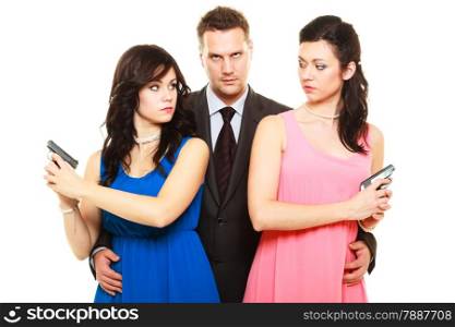 Jealousy between women relationship in triangle. Two elegant female with guns and man in suit isolated on white. Studio shot.