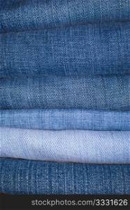 Jeans Background - Stack of Jeans Trousers in Different Shades of Blue