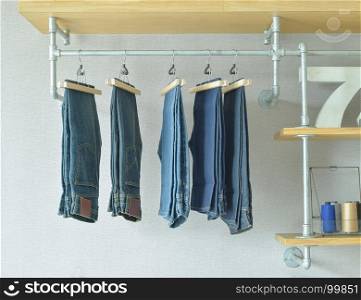 jeans hanging in industrial style walk in closet