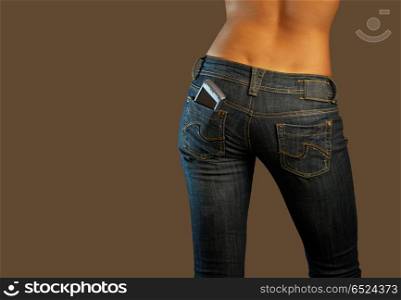 Jeans imaginations (communications). The bottom part of the girl in jeans with cellphone in a pocket