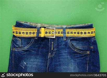 jeans with meter belt slimming on the green background