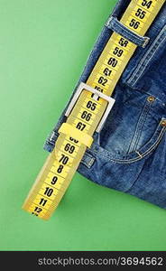 jeans with meter belt slimming on the green background