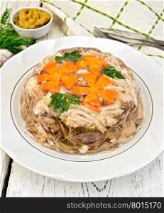 Jellied pork and beef with carrots and parsley on a plate, tea towel, garlic, mustard and dill on a wooden boards background