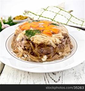 Jellied pork and beef with carrots and parsley on a plate, towel, garlic, mustard and dill on a wooden boards background