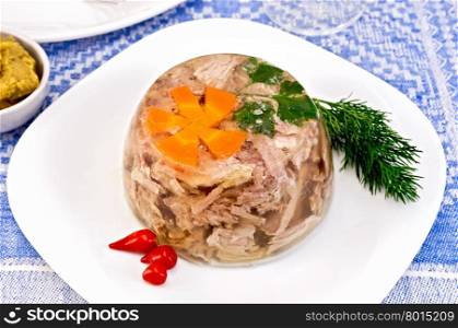Jellied pork and beef with carrots and parsley on a plate with a sharp pertsemey and dill, mustard on a background of a linen tablecloth